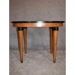 A Continental Art Deco bird's eye walnut centre table with oval ebonised top on circular tapering