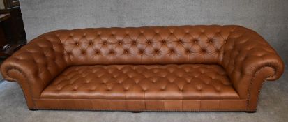 A four seater Chesterfield sofa by George Smith upholstered in deep buttoned tan leather. H.65 x 274