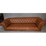 A four seater Chesterfield sofa by George Smith upholstered in deep buttoned tan leather. H.65 x 274