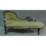 A Victorian carved mahogany framed chaise longue in sage buttoned upholstery on cabriole supports