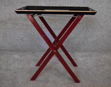 A lacquered twin handled tray on (associated) stand H.60 x 60cm