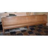 An oak church pew fitted with electrical heater, in working order. L.275cm