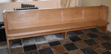 An oak church pew fitted with electrical heater, in working order. L.275cm