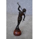 A 19th century bronze figure of Peter Pan on rouge marble circular base, signed. H.15cm