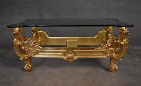 A gilt Rococo framed coffee table with shaped and decorated plate glass top. H.53 x 122cm