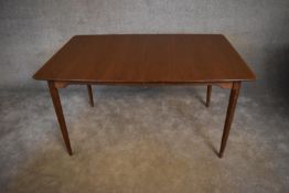 A mid 20th century teak extending dining table, with two extra leafs. H.74 x 137cm (ext. 193cm)