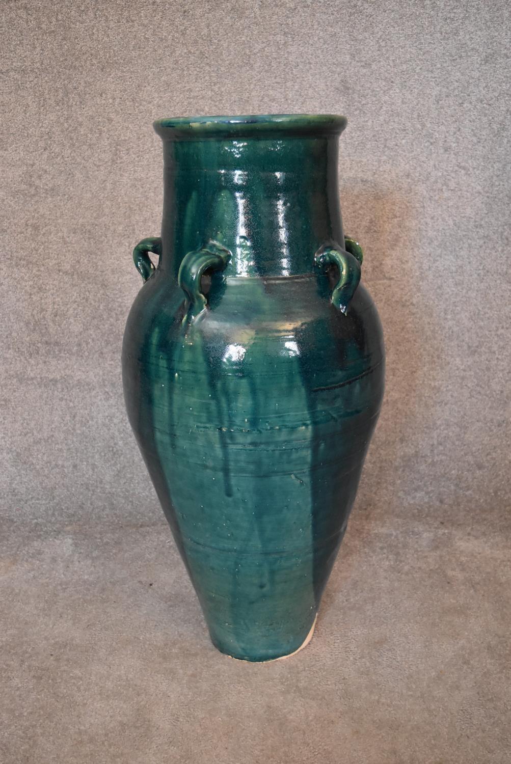 A large green drip glazed sharab wine vessel with six handles. H.93 x 30cm