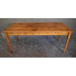 A large 19th century pitch pine kitchen refectory dining table with planked top on ring turned