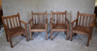 A set of four teak garden armchairs. H.87 x 60cm