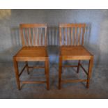 A pair of teak high stools. H.100 x 50cm