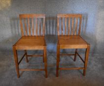 A pair of teak high stools. H.100 x 50cm