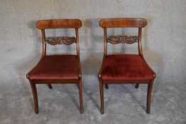 A pair of 19th century mahogany and line inlaid dining chairs on sabre supports. H.80 x 50cm