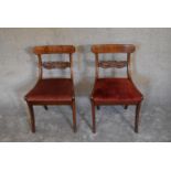 A pair of 19th century mahogany and line inlaid dining chairs on sabre supports. H.80 x 50cm