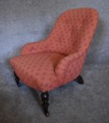 A Victorian mahogany framed button backed nursing chair upholstered in rouge fabric. H.69 x 55cm