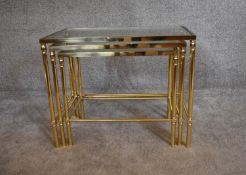 A nest of three brass framed and glass topped graduating occasional tables. H.48 x 60cm