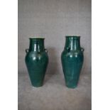 A pair of large green glazed sharab wine vessels. H.90 x 26cm