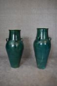 A pair of large green glazed sharab wine vessels. H.90 x 26cm