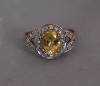 A modern Lemon apatite and zircon cluster ring. Set to centre with an oval mixed cut Lemon Apatite