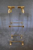 An Empire style gilt framed lamp table with clear perspex and glass fittings, shelves and tops and
