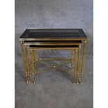 A nest of three brass framed and glass topped graduating occasional tables tables. H.48 x 60cm