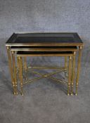 A nest of three brass framed and glass topped graduating occasional tables tables. H.48 x 60cm