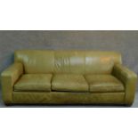 A pale green leather sofa raised on block feet. By Crate & Barrel. H.81 W.220 D.91cm
