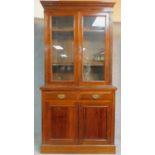 A late 19th century walnut library bookcase with glazed upper section above pair of frieze drawers
