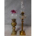 Two Victorian brass oil lamps. One with ridged column design on a square base and the other with