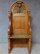 A 19th century oak hall bench with cherub carved mask above panel back on solid seat. H.169 W.75 D.