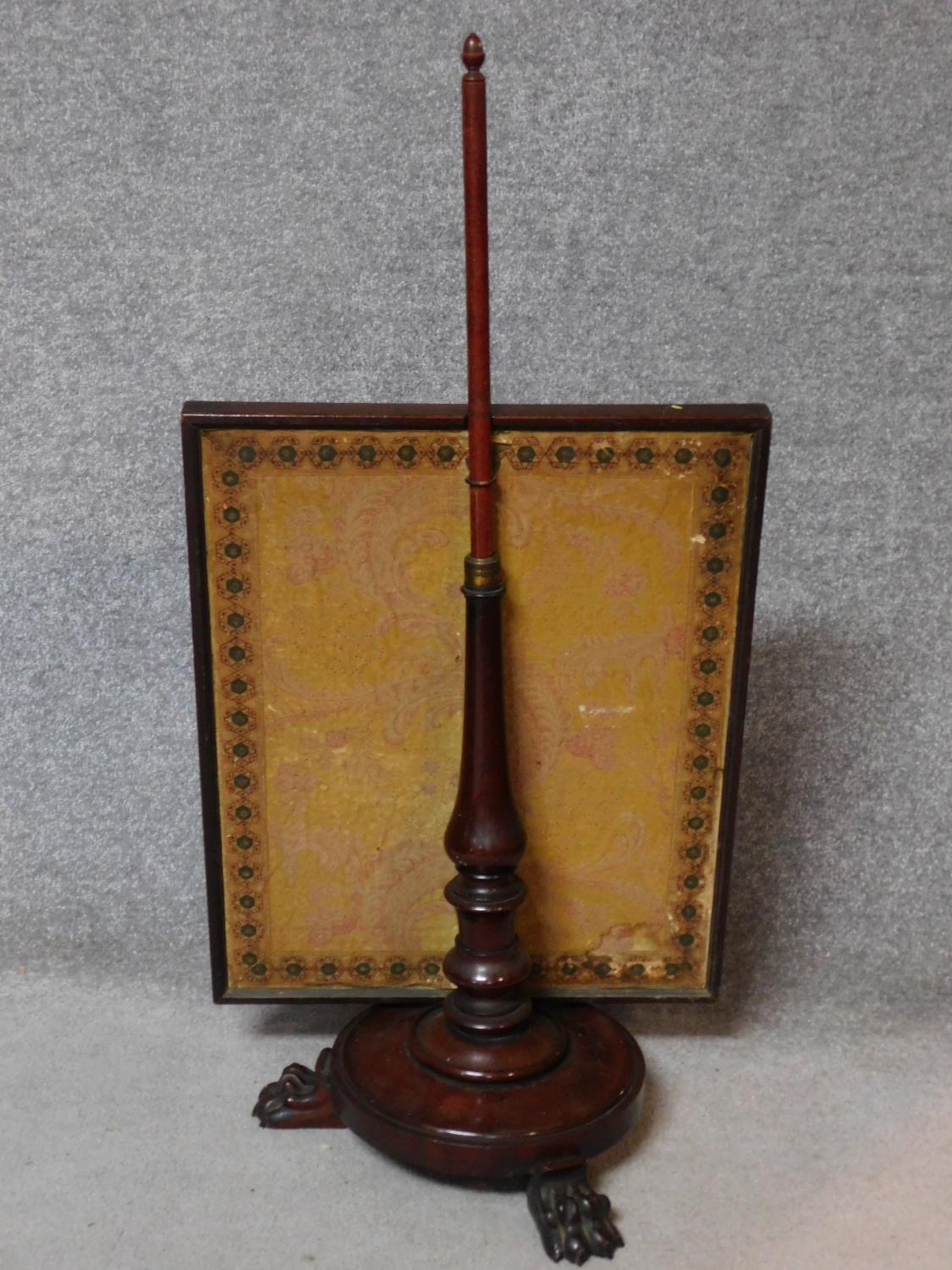 A William IV mahogany pole screen on circular platform base resting on carved lion paw feet. H.102cm - Image 3 of 4