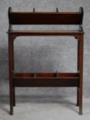 A late Victorian mahogany book trough with under tier, raised on square stretchered swept