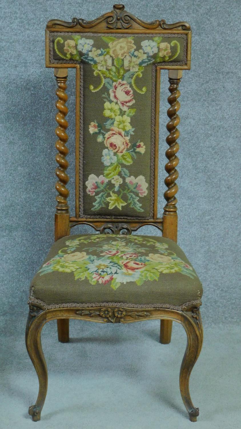 A Victorian rosewood floral carved and upholstered prie dieu chair raised on cabriole legs. H.111cm