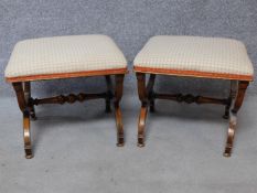 A pair of early Victorian mahogany footstools with stuffover upholstered seats on stretchered x