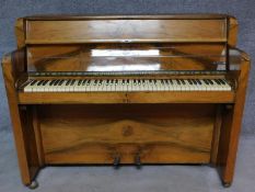 An Art Deco figured walnut upright piano, by Nathaniel Berry & Sons. H.106 W.133 D.48cm