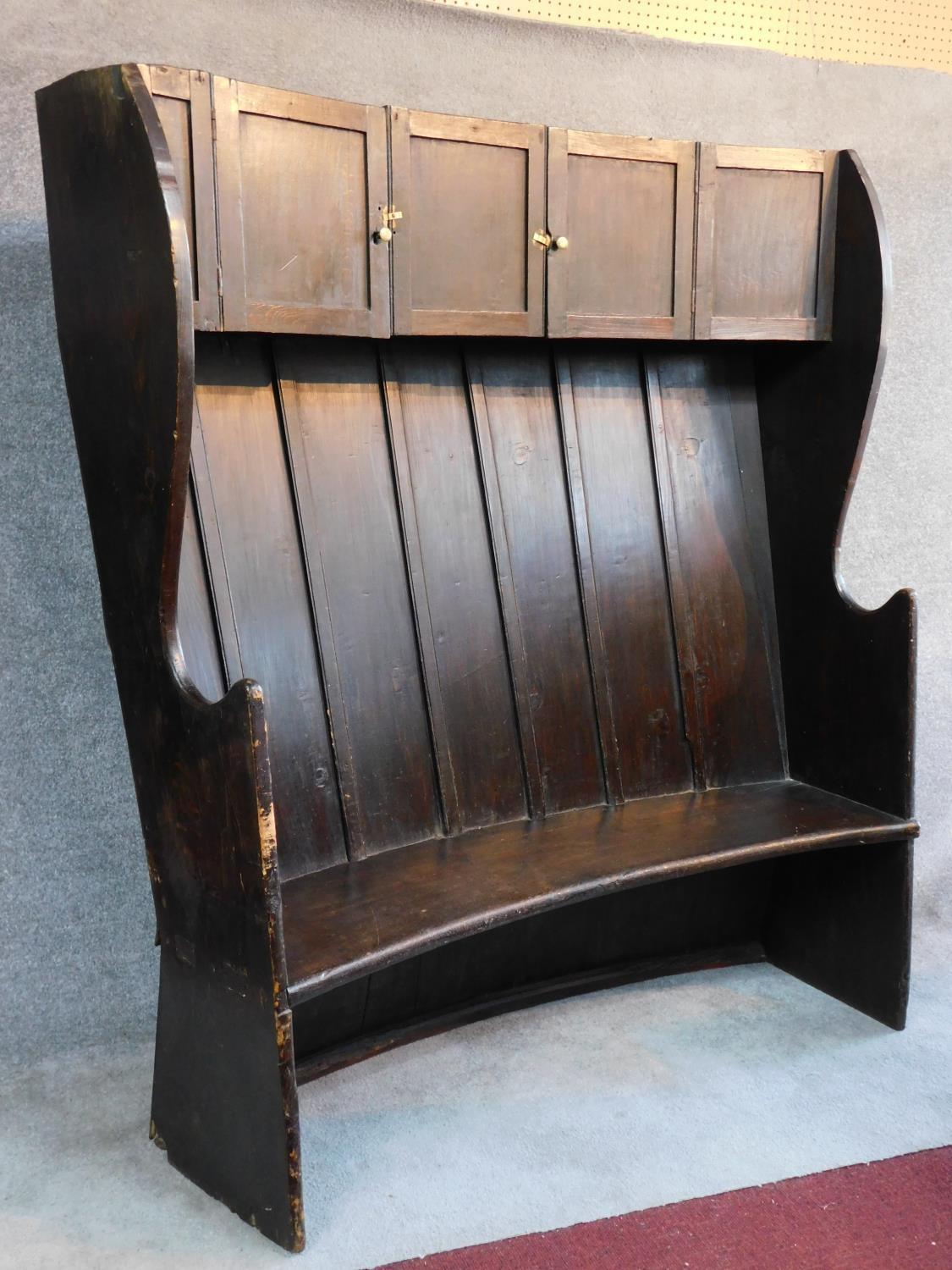 A large Georgian oak hall bench of curved outline fitted cupbooards to the upper section. W.146 D. - Image 3 of 4
