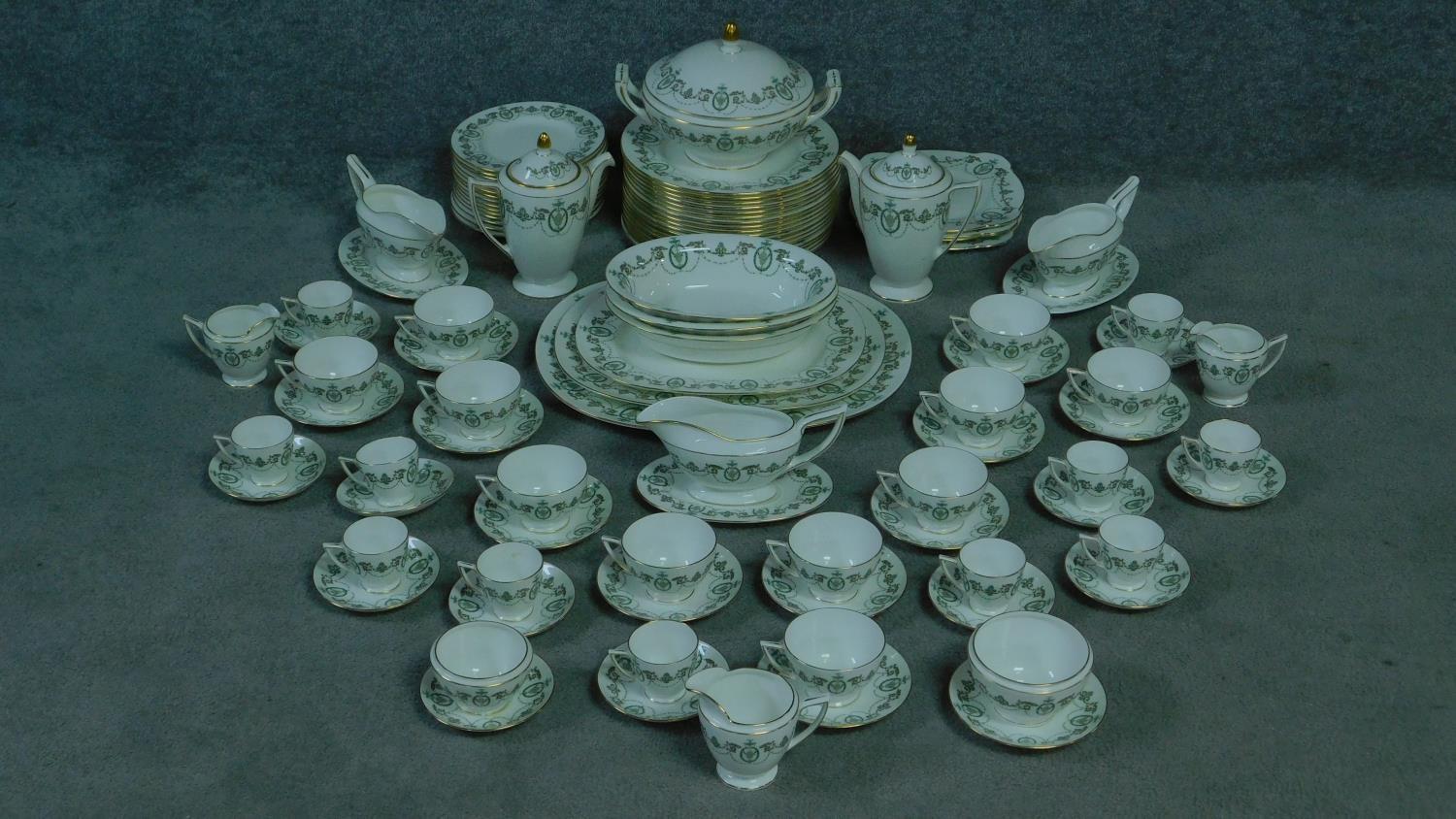 A Minton Adam design complete tea set. With swages and foliate design. Gilding to the handle and