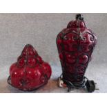 A pair of 1920's blown red glass lights, one table lamp with wirework design and one similar