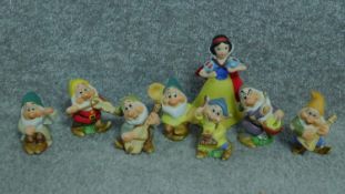 A collection of porcelain hand painted figures of Snow White and the seven dwarves by Schmid for The
