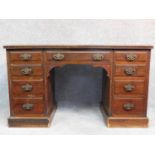 A Edwardian mahogany pedestal desk with an arrangement of nine drawers on plinth base. H.75 W.130