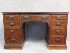 A Edwardian mahogany pedestal desk with an arrangement of nine drawers on plinth base. H.75 W.130