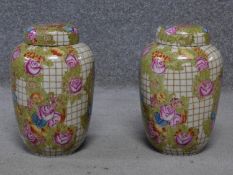 A pair of hand painted lidded crackle glaze ginger jars by Chinese porcelain maker Wong Lee. Painted