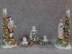 A pair of antique hand painted and gilded German porcelain Sitzendorf figural candle sticks with