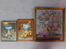 Three framed embroideries depicting flowers and fruits on a table. the largest by Leah Luck, paper