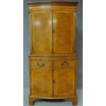 A Georgian style burr walnut tallboy cabinet with internally lit upper section above frieze