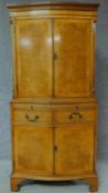 A Georgian style burr walnut tallboy cabinet with internally lit upper section above frieze