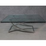 A contemporary glass coffee table raised on chrome supports, by Rolf Benz. H.42 W.120 D.90cm