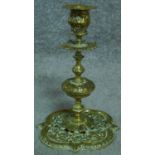 Two pairs of antique brass candle sticks. One set with pierced repousse decoration featuring