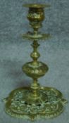 Two pairs of antique brass candle sticks. One set with pierced repousse decoration featuring