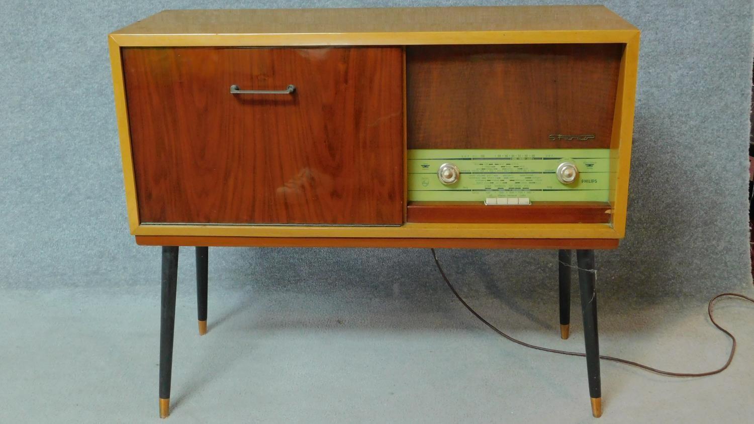 A 1960's vintage satin walnut and teak dancette supports radiogram, by Philips. H.76 W.92 D.36