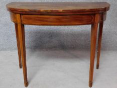 An Georgian mahogany and inlaid foldover top card table, raised on square tapering supports. H.72